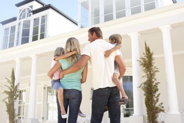 Young Family Standing outside Dream Home